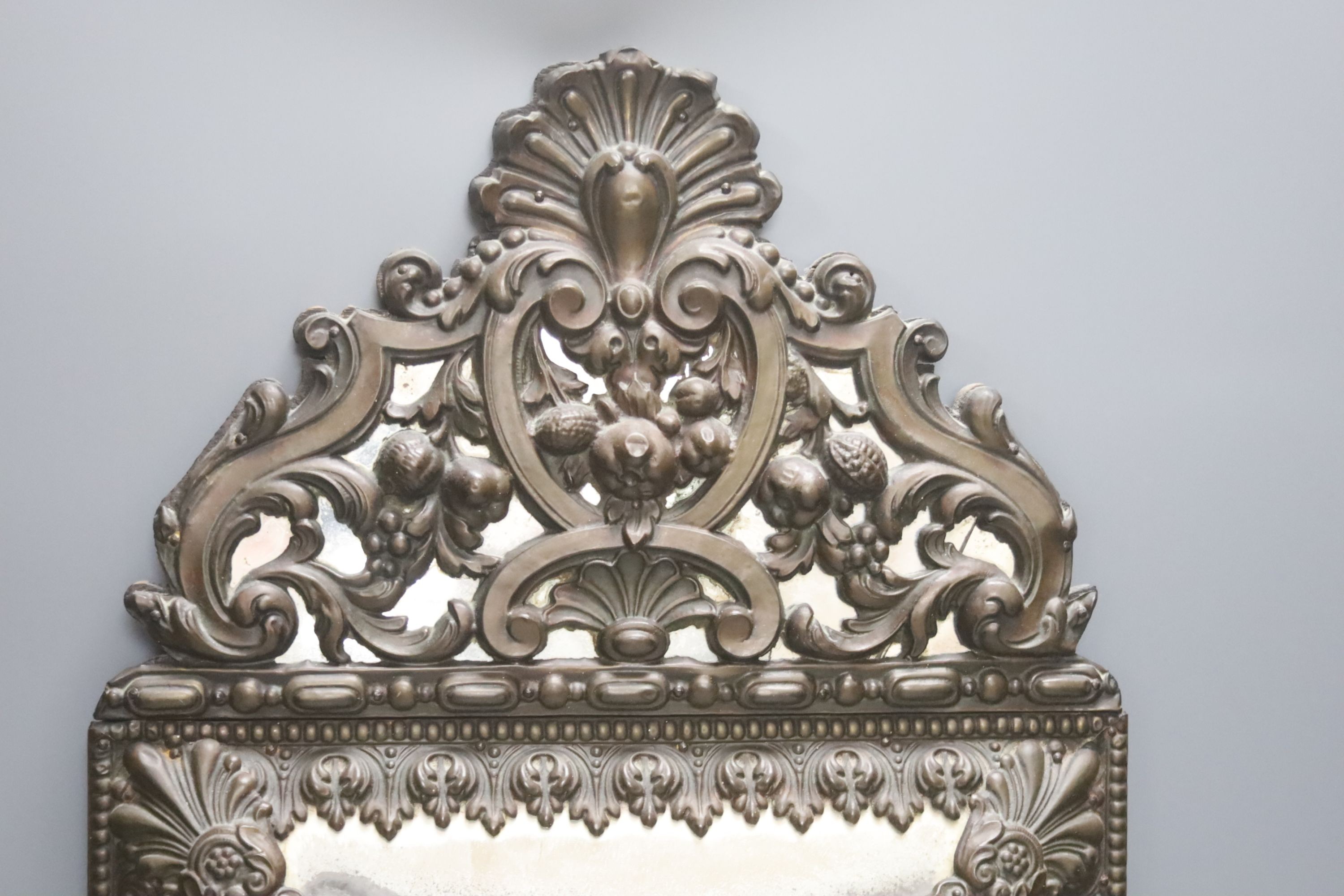 A 19th century Dutch embossed copper mounted wall mirror 58cm